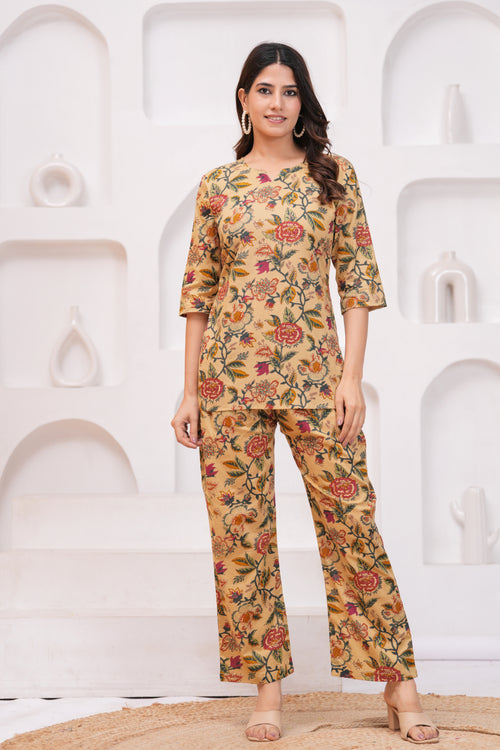 Woman wearing a floral outfit against a white abstract sculpture background